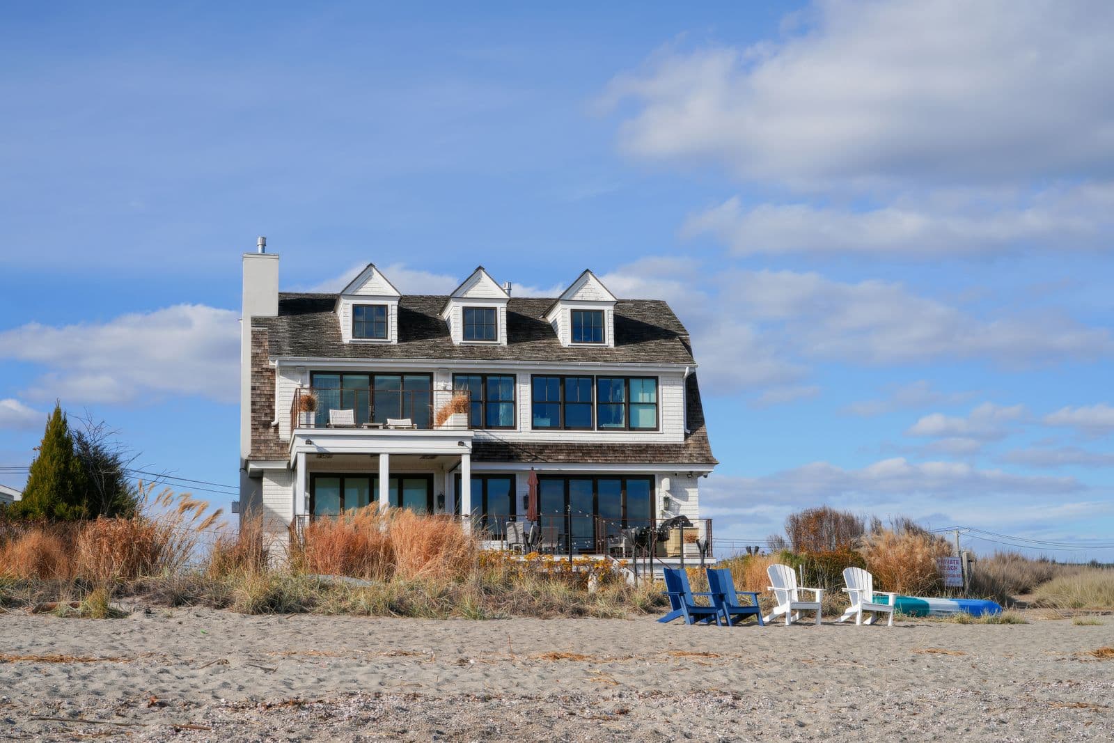 A weatherboard beach house behind the dunes