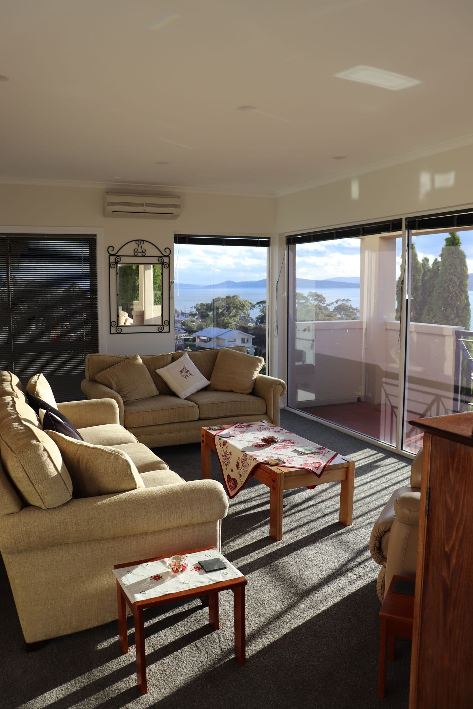 Sofas by a window with an ocean view