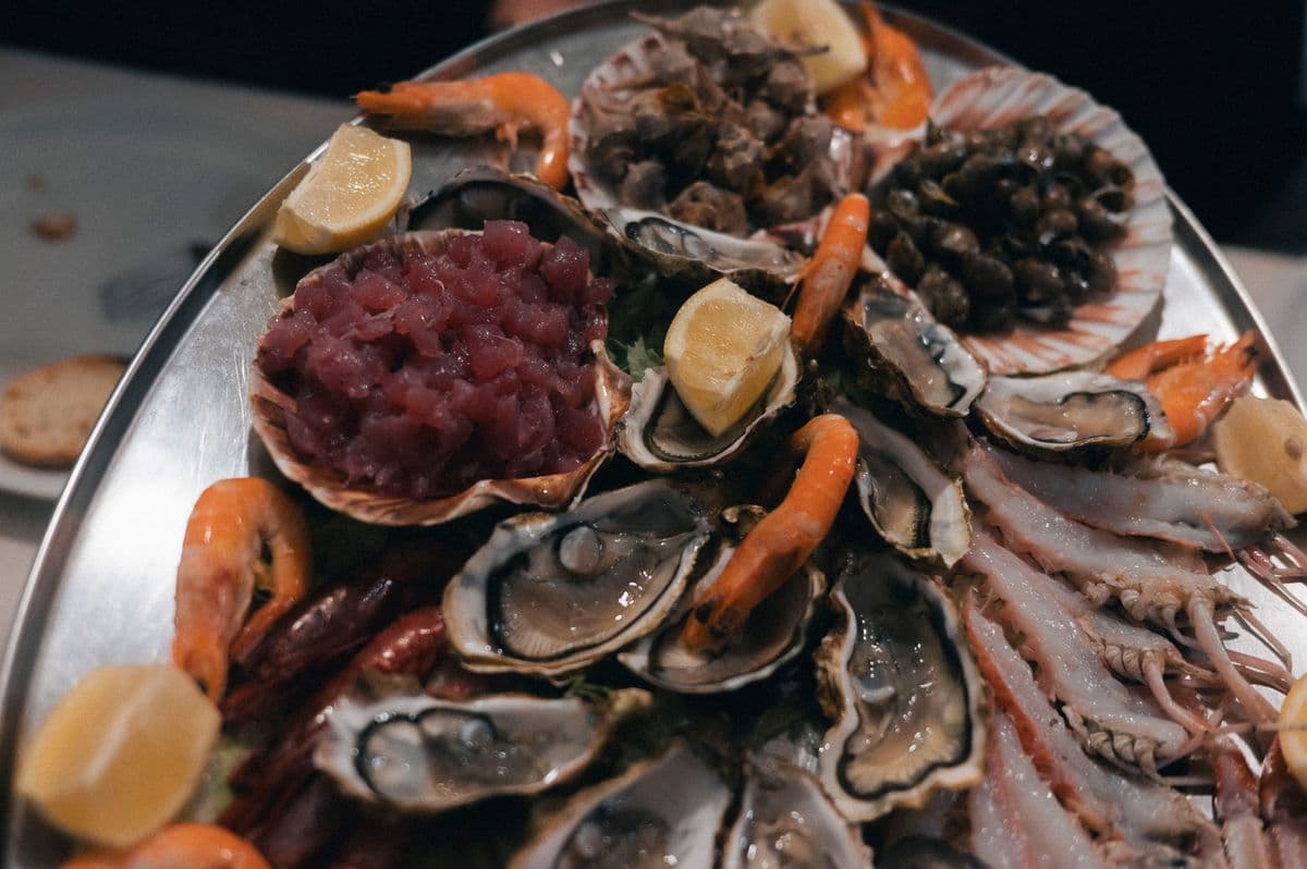 A seafood platter with fresh oysters, prawns and lemon